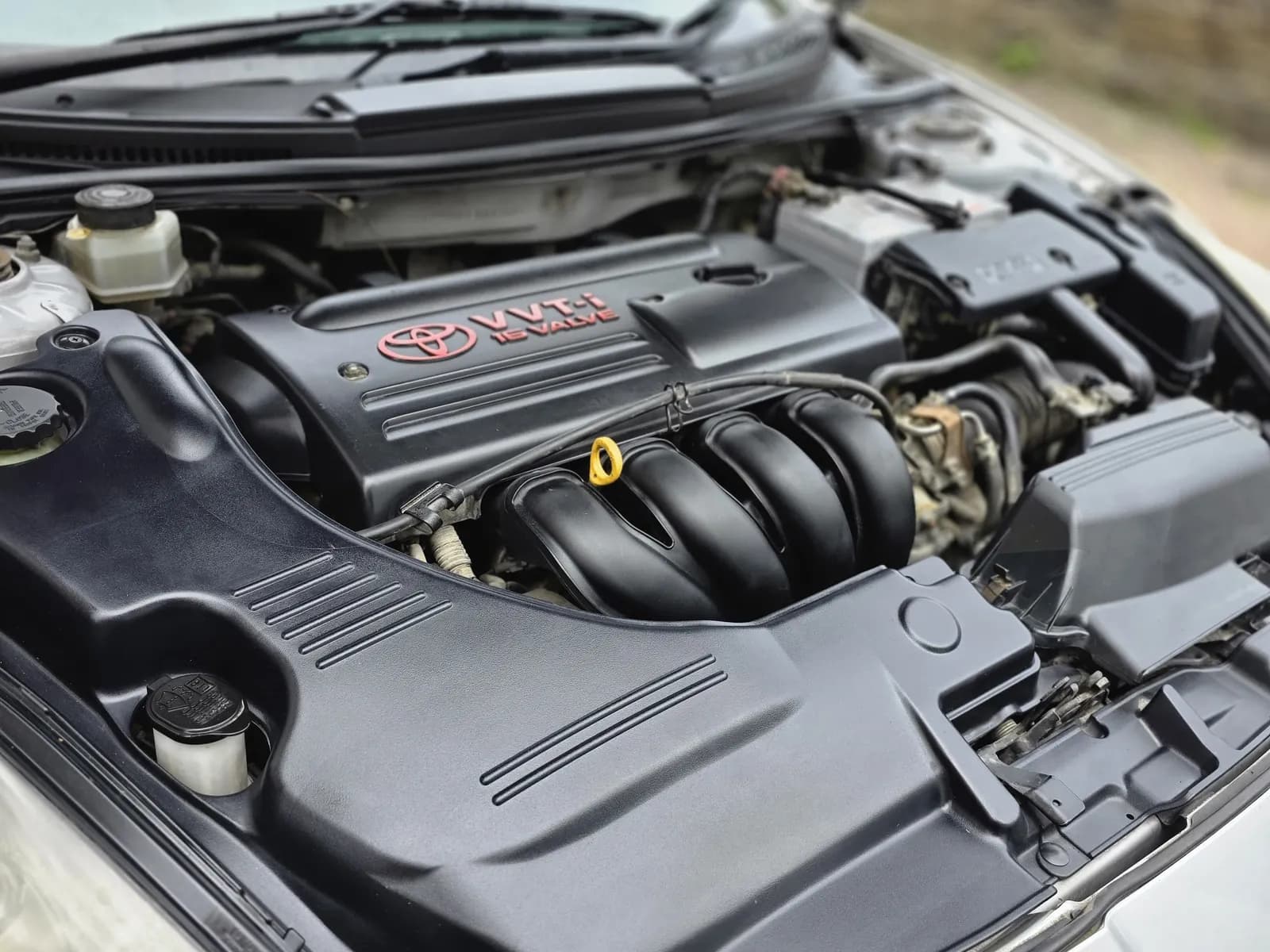 Engine bay cleaning — Toyota VVT-i bay with plastics dressed back to black