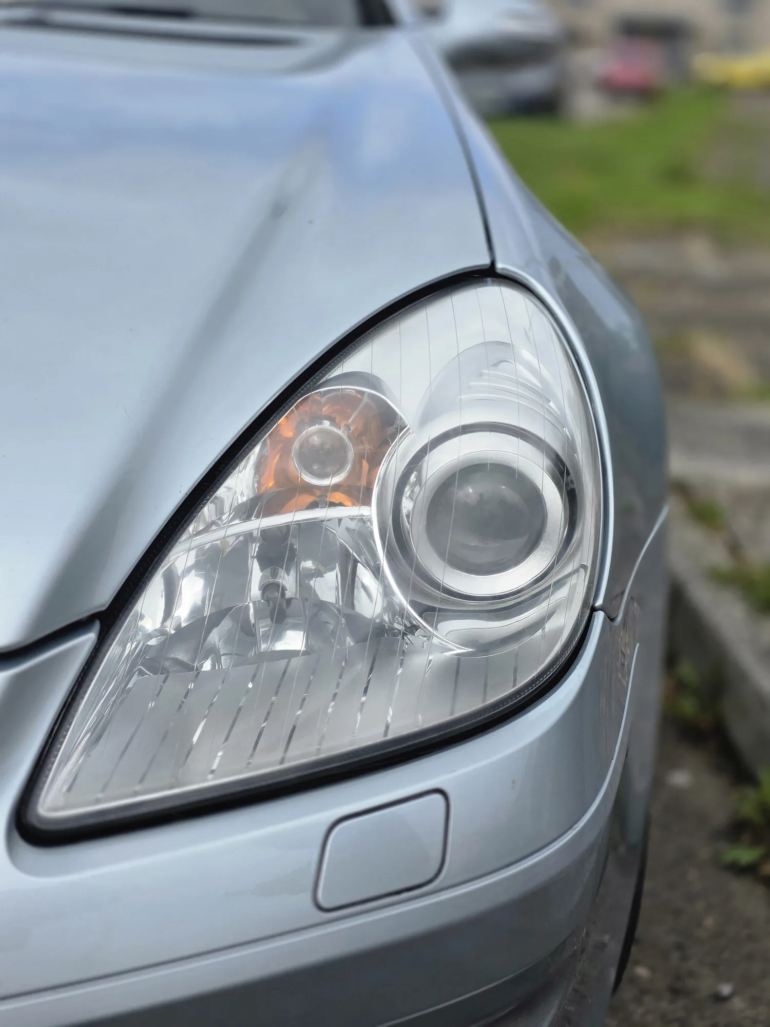 The same headlight after restoration — clear lens with the projector and reflector visible